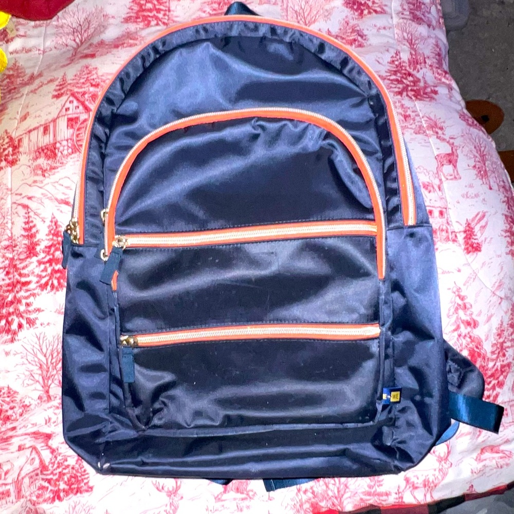 Me to We navy blue and inside red backpack